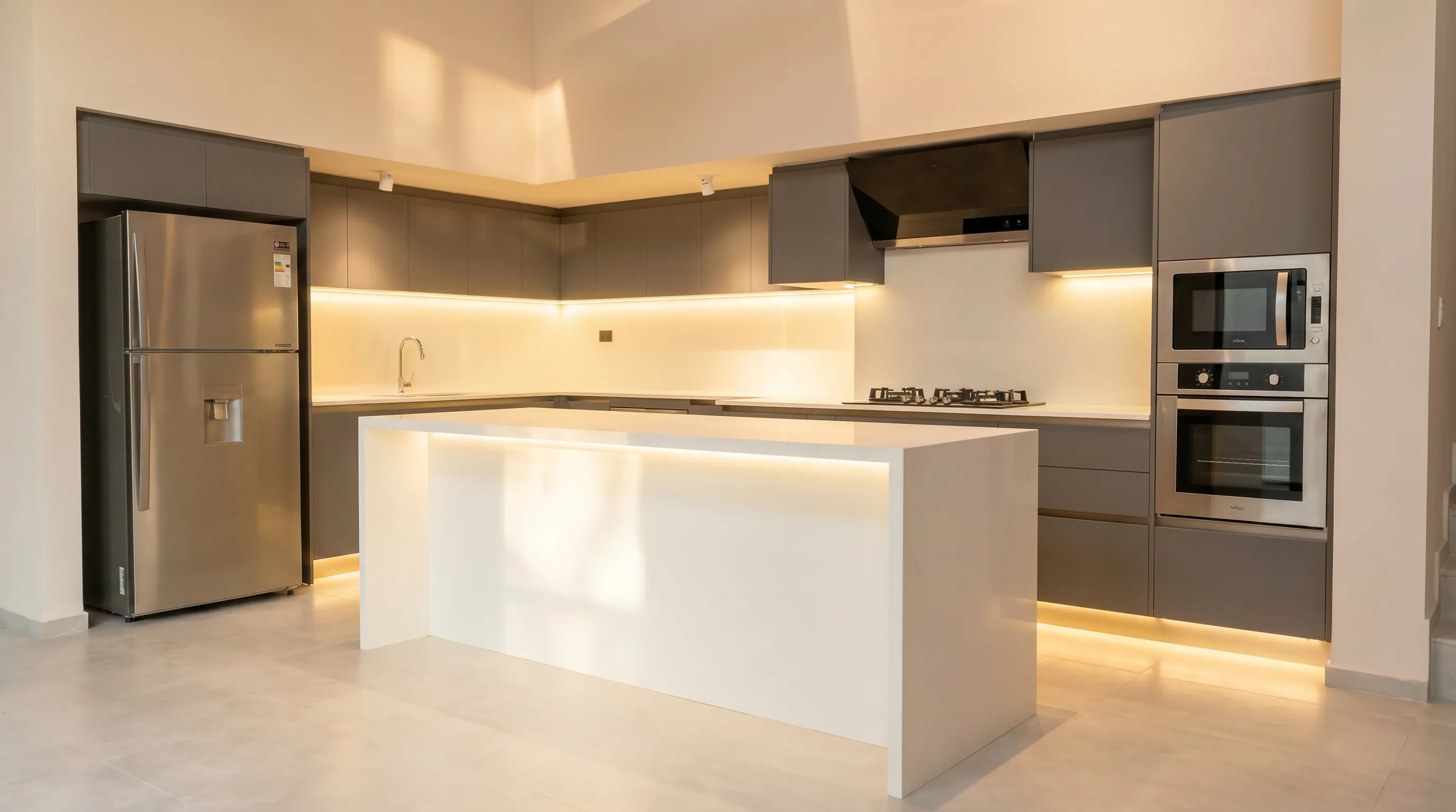 Modern kitchen with waterfall island and warm lighting
