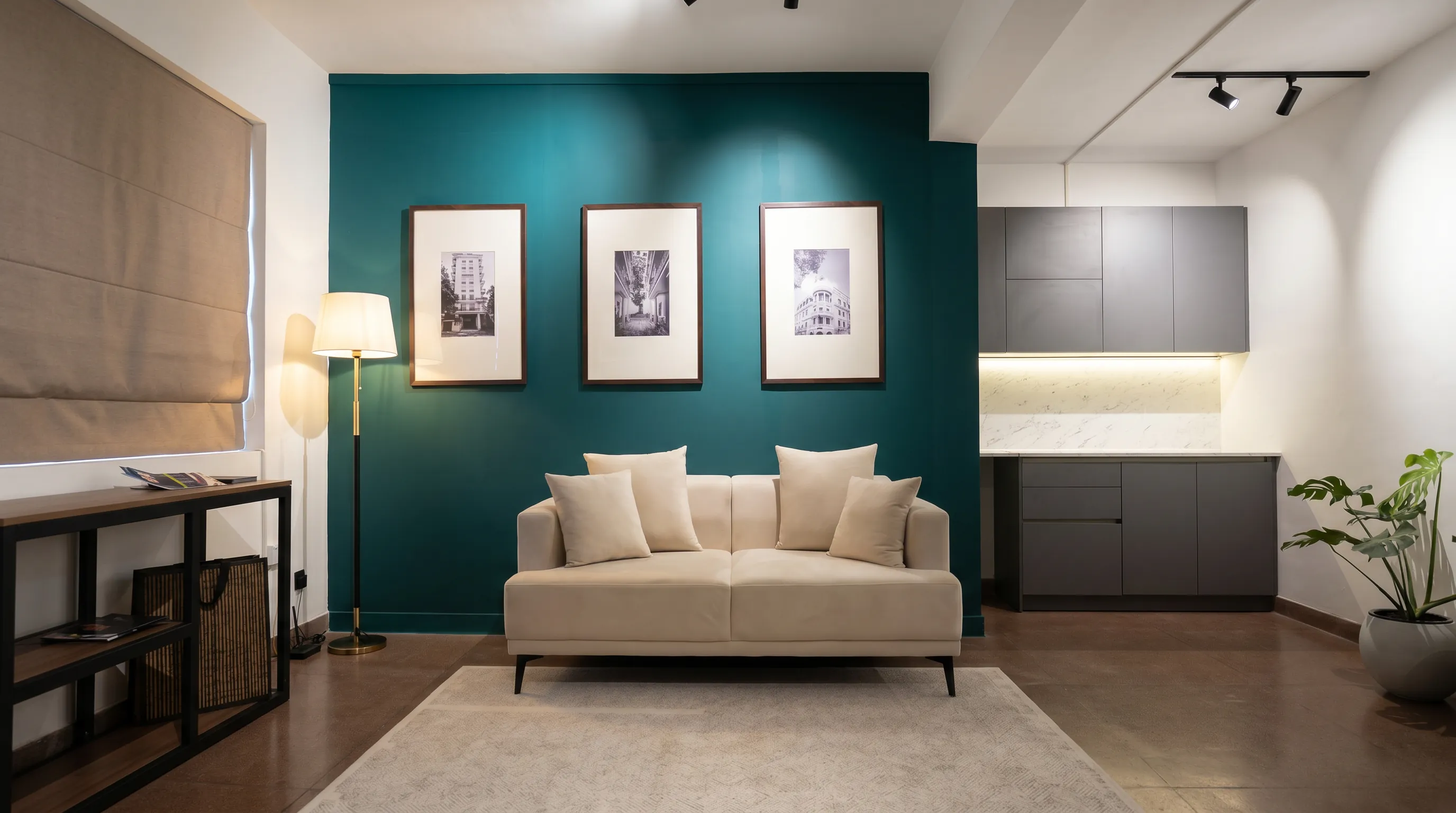 Teal accent lounge with framed art and bespoke cabinetry